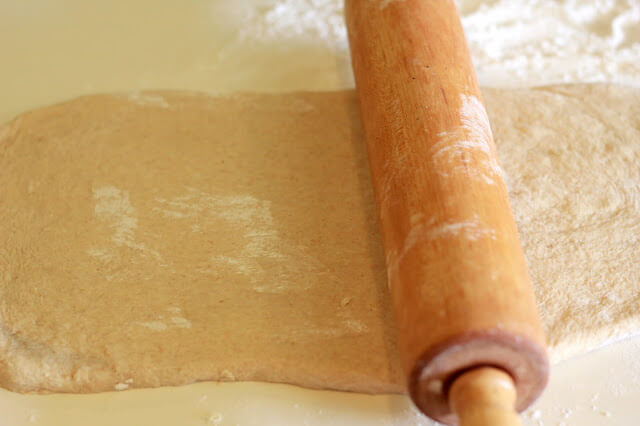 bread dough flattened by a rolling pin