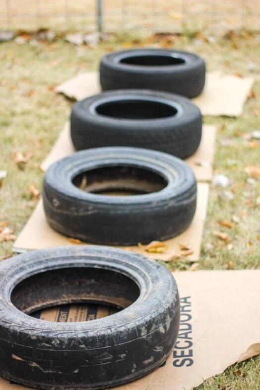 tires layed out on cardboard squares in a backyard