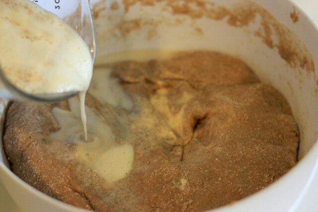 yeast mixture being added to bread dough