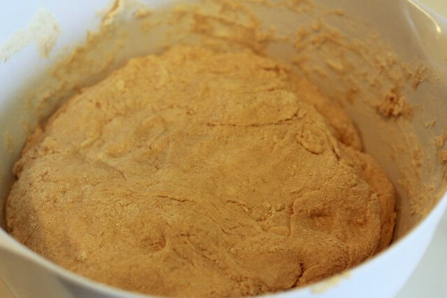 thickening bread dough in a white bowl