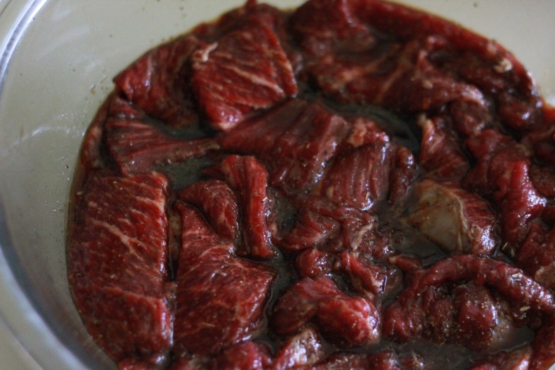 strips of bear meat in marinade
