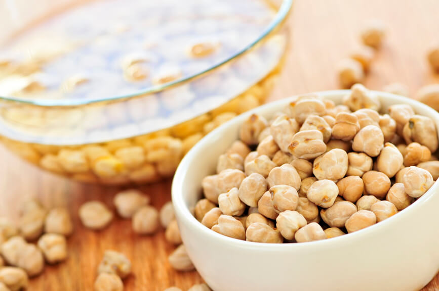 nuts in a bowl and soaking in a glass bowl filled with oil