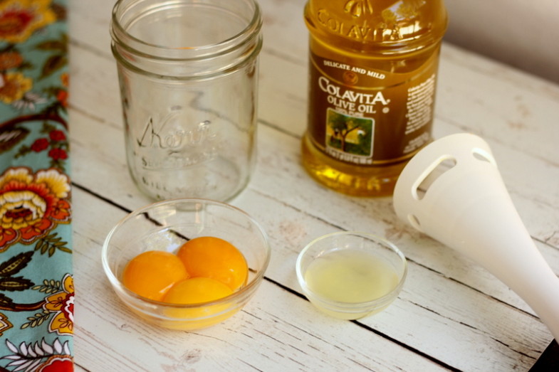 ingredients for homemade mayonnaise and immersion blender on weathered white wooden table