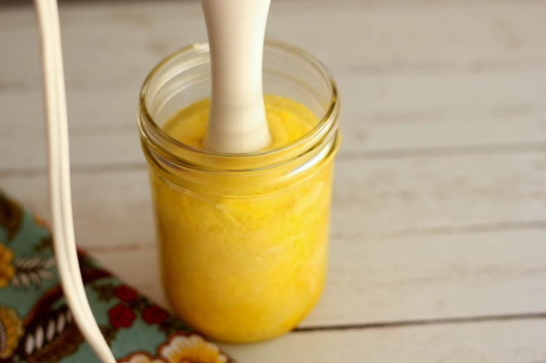 homemade mayonnaise taking form in a jar with immersion blender