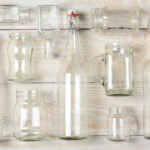 Assorted Clear Glass Bottles on White Wood