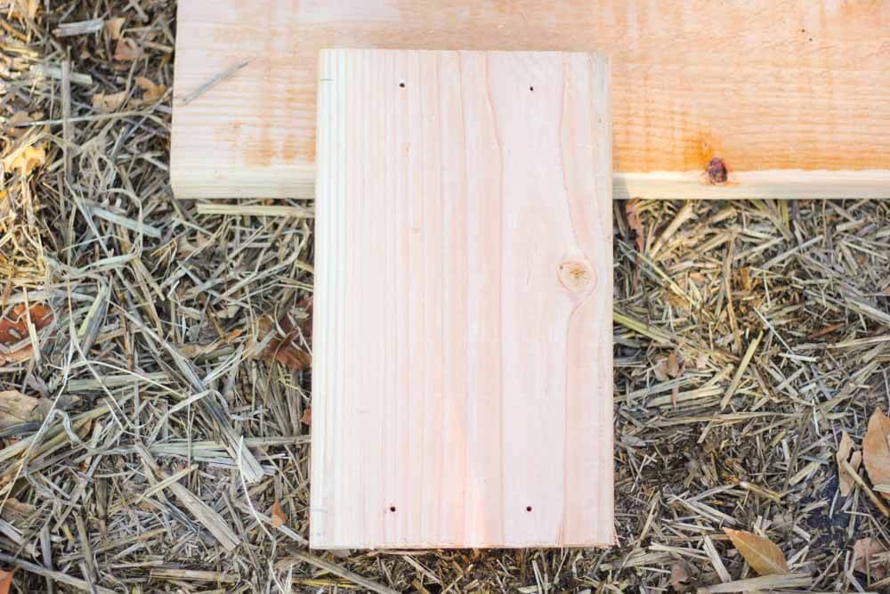 boards with drilled holes lying on top of hay