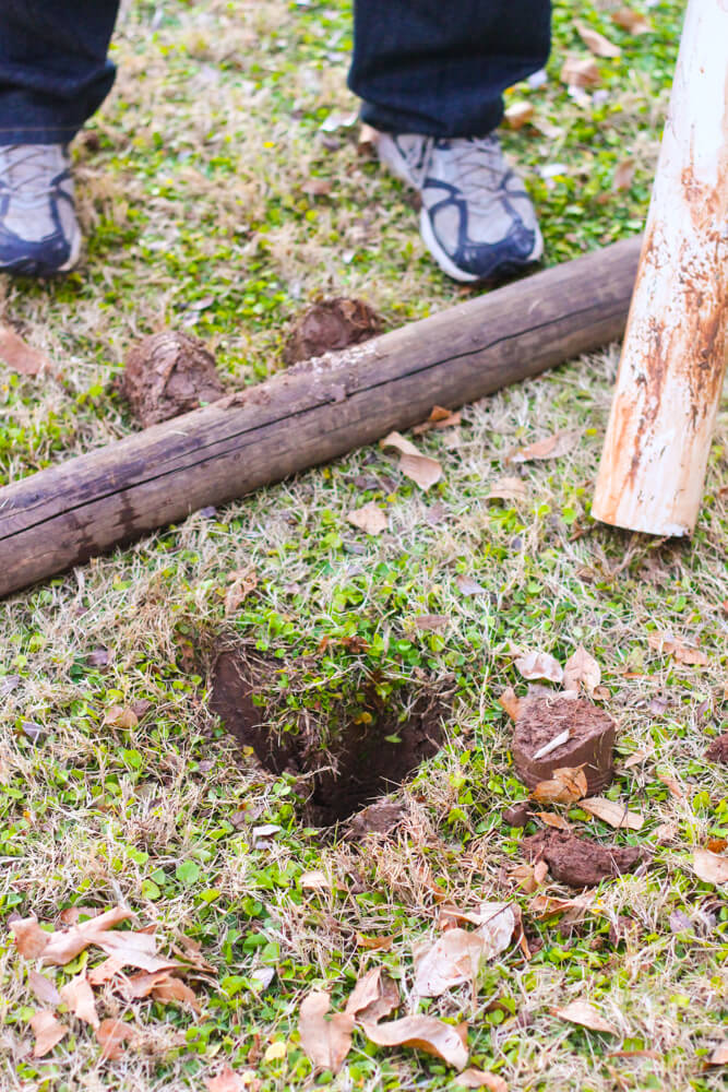 close up shot of man wearing sneakers near posts and hole