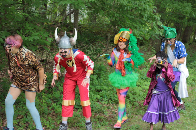 five children wearing mismatched costumes