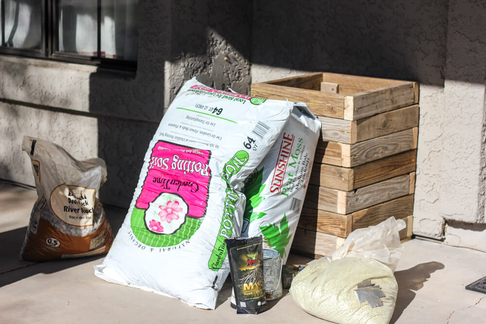 stack of soil bags and gardening supplies