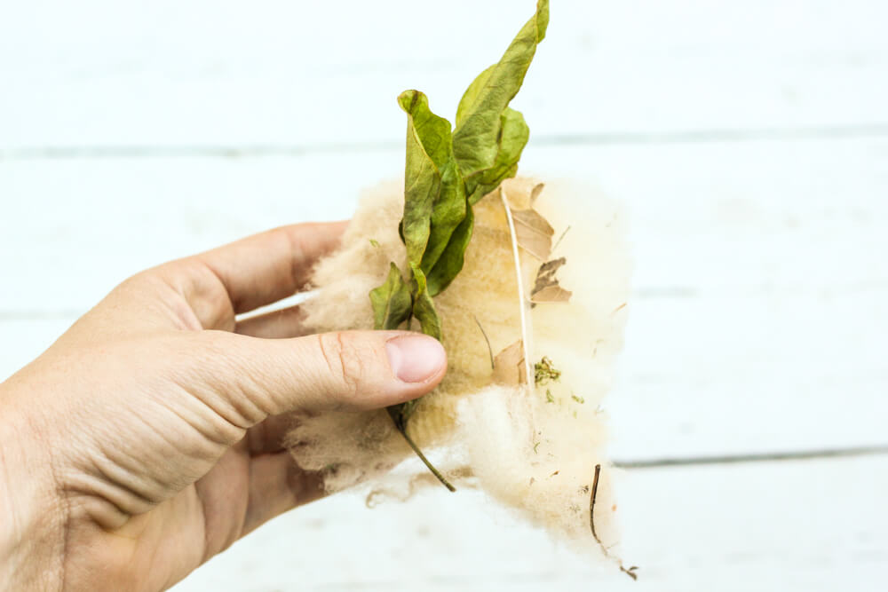 hand holding up materials for wool tampons