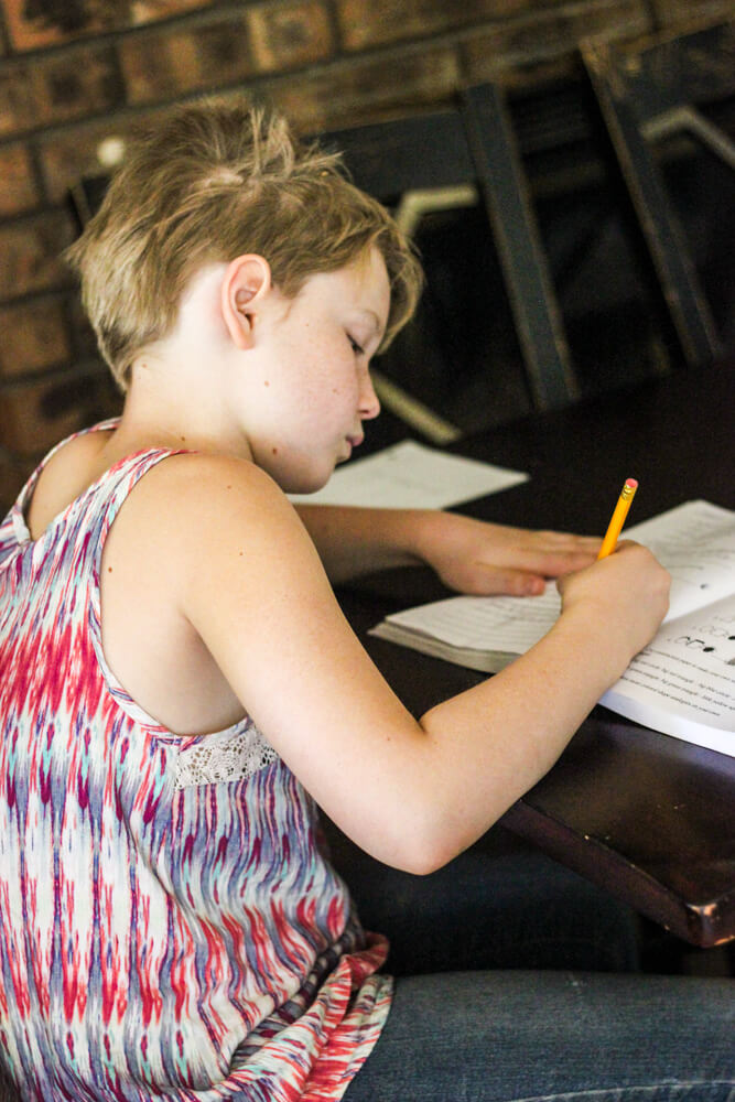 casually dressed student working through workbook