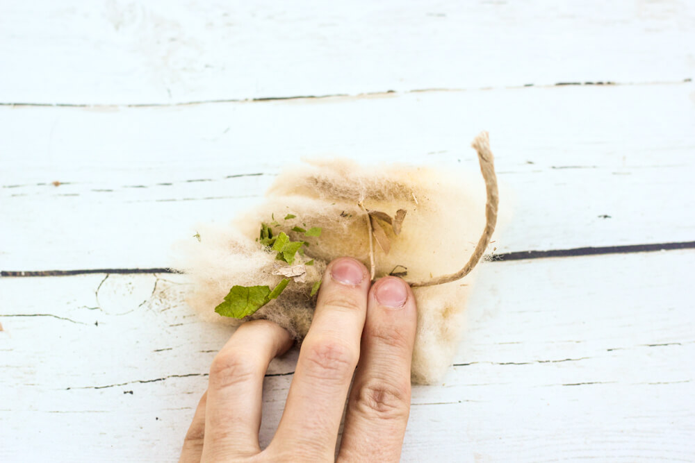 hand pressing wool tampon in place