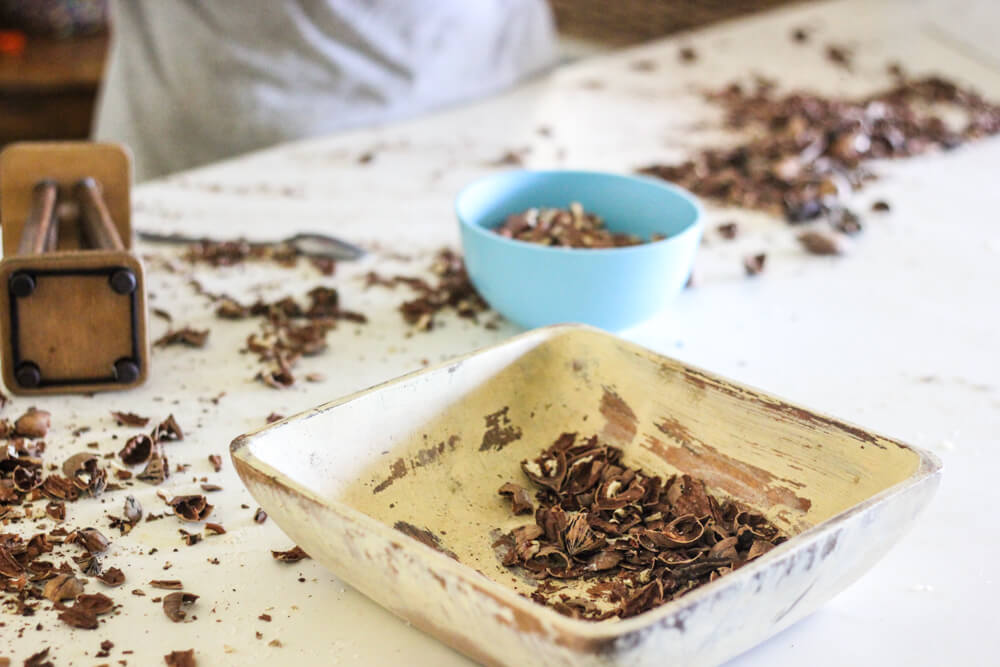 table wherein people are cracking open pecan nuts