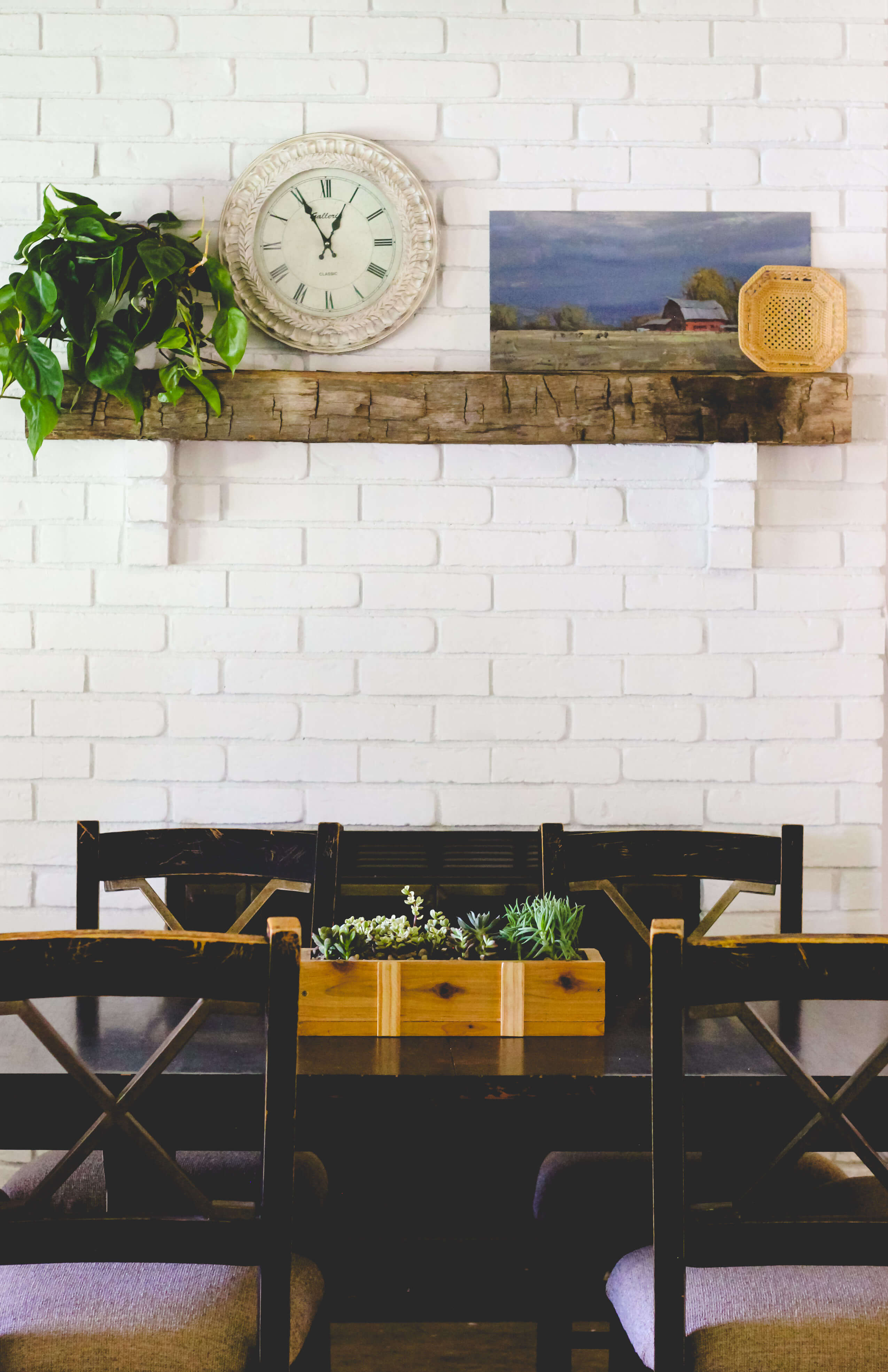 White fireplace modern farmhouse with succulents.