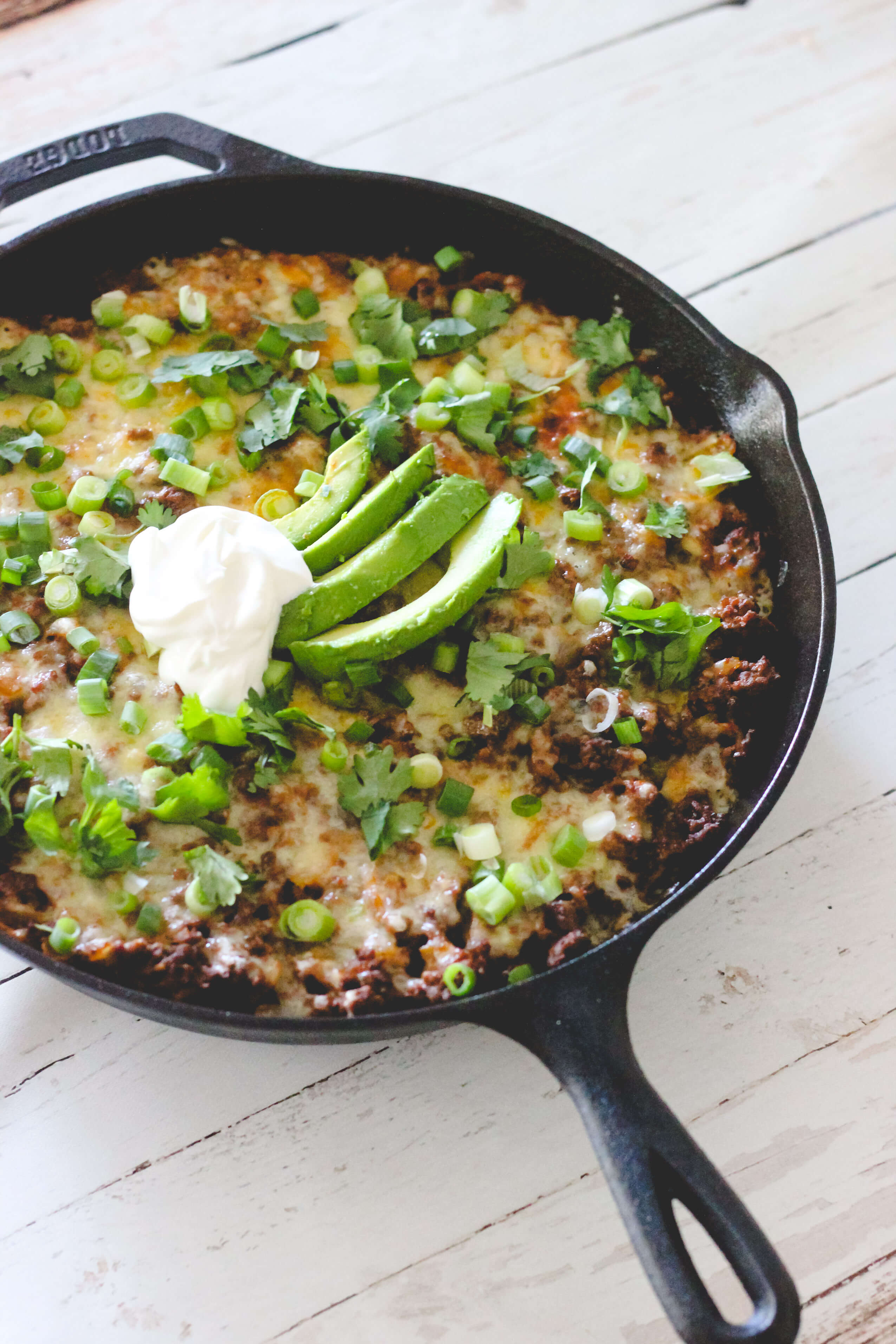 Tamale pie with cilantro, avocado, & sour cream.