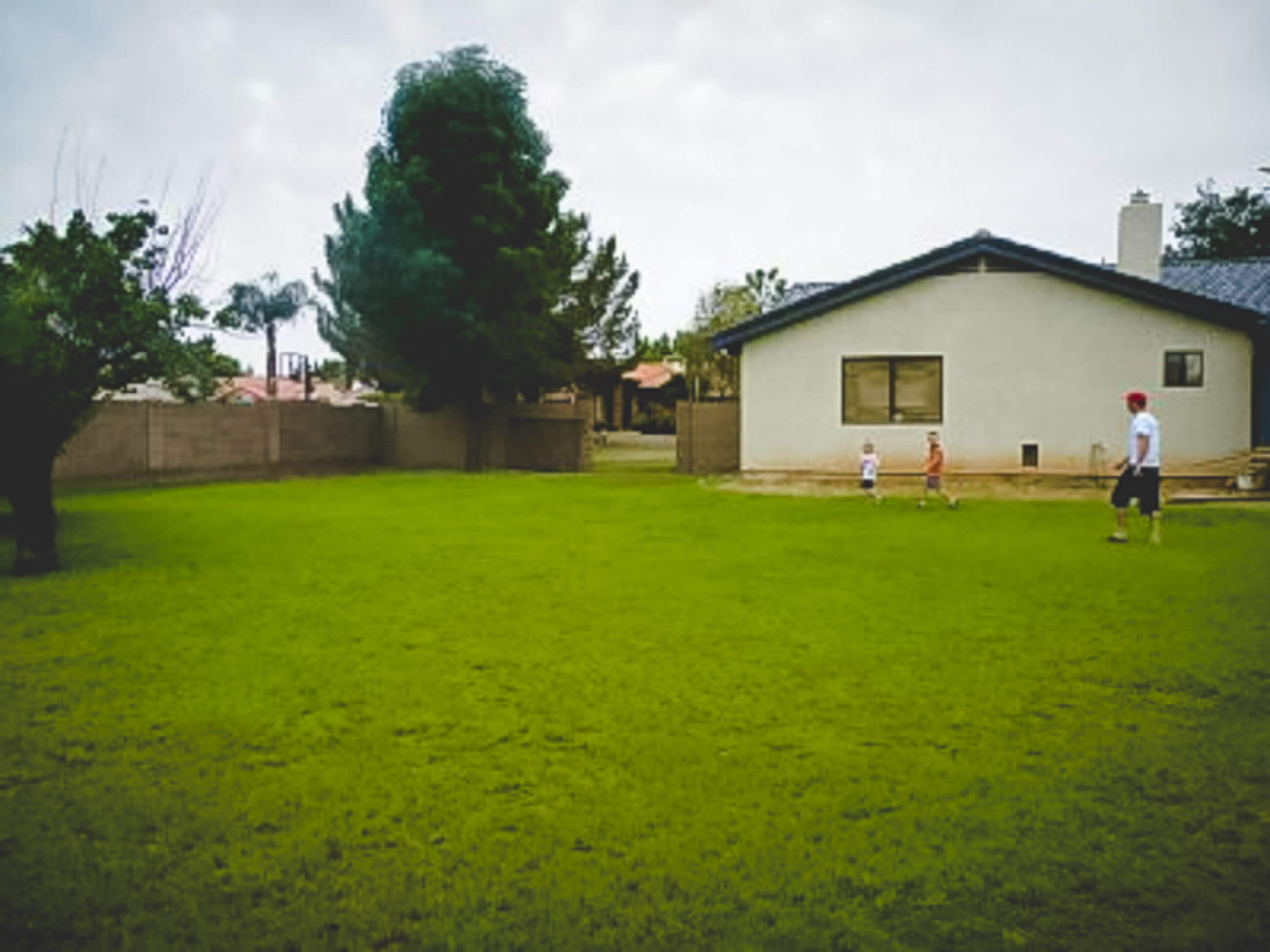 White house with large backyard