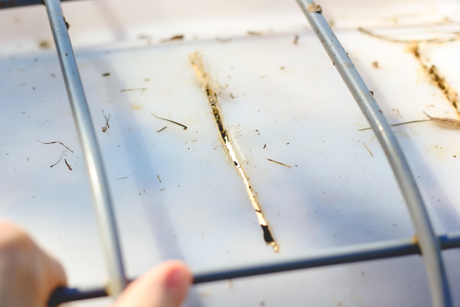 Closeup of holes cut in compost bin