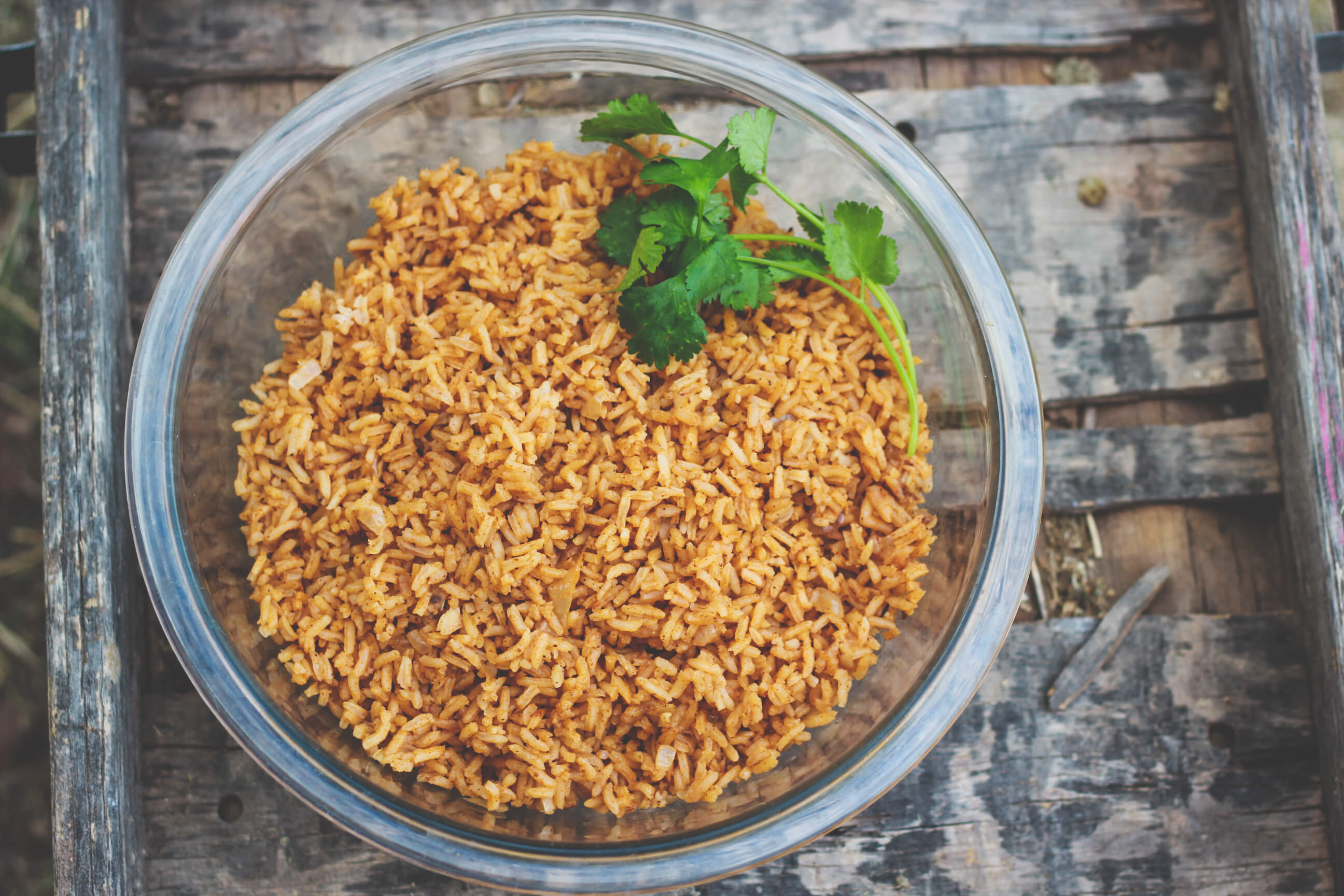 Bowl of Spanish rice on wood backdrop